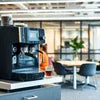 Modern coffee vending machine with grinder for office use in a sleek workspace