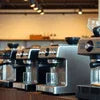 Multiple Atlantis Neo 3 Lane espresso machines in silver stainless steel for office coffee vending use