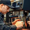 Automatic coffee machine warranty guide with barista using machine for cafe vending