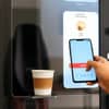 Smart coffee vending machine with UPI payment showing phone scan for office vending