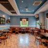 Blue Tokai Coffee Ghaziabad cafe interior with wooden tables and chairs for relaxed coffee breaks