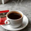 Atlantis Coffee Premix Powder Ghaziabad single serve pack with hot coffee cup for cafe vending