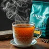 ATLANTIS PREMIX coffee pack with steaming cup of brewed coffee in glass for office use