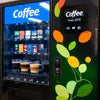 Coffee vending machines branded with ATLANTIS PREMIX featuring multiple selections and decorative floral design