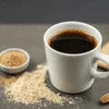 White ceramic cup of black coffee with brown sugar and NESCAFE COFFEE MACHINE RENTAL for office use