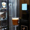 Black office coffee vending machine dispensing brown coffee in clear cup using office coffee PREMIX
