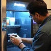Technician performing Tea Coffee Vending Machine Maintenance Delhi on a black office vending machine
