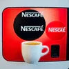 Red Nescafe coffee vending machine premix with dual logo panel and cup display for office use
