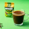 Amazon brand coffee machine rental with compact green vending coffee pod and glass cup of black coffee