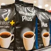 Amazon Plus instant coffee premix for offices black and blue packaging with cup of coffee displayed
