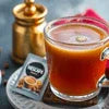 Nescafe cardamom tea premix cup with tea and spice grinder showing nescafe cardamom tea premix benefits