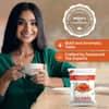 Amazon Plus Masala Tea 3-in-1 premix 1 kg pack with a woman enjoying tea in a kitchen setting