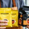 Atlantis coffee premix plus in yellow and black vending and office use packs held by person