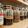 Atlantis Coffee Premix Plus review showing glass jars with coffee premix blends in a row for office vending use