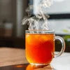 Glass mug of steaming Amazon Plus Tea Premix best price served hot, ideal for office or vending use