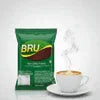 BRU coffee premix green pack beside steaming cup for office and vending use
