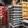 Stacks of Amazon Plus tea premix wholesaler Delhi NCR packaged in black bags for office use