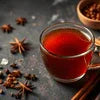 Best masala tea premix for offices in Delhi with warm spiced tea in clear glass cup and star anise