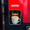 Red coffee vending machine dispensing hot beverage into white cup for hot beverage vending service Gorakhpur