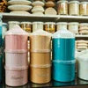 Atlantis premix powder in pink brown and blue containers for office and vending use