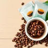 Premium coffee beans for offices in Delhi with brown roasted beans in white cup and scattered beans