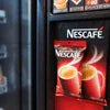 Nescafe coffee premix vending machine with red and black branded packaging for office use