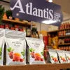 Atlantis Plus tea premix distributor NCR displaying Atlantis Plus tea premix packets with colorful fruit images for office or vending use
