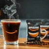 Amazon Coffee Premix Jodhpur pack with steaming black coffee and coffee beans for office use