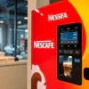 Red Nescafe vending machine model in office setting with digital interface for coffee dispensing Nescafe Vending Machine Pune