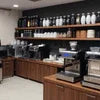 Coffee machine dealer showroom with black Jura and Saeco machines for office use on wooden counters