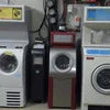 Machine Rental NCR showing front-load washing machines in white, black, and red colors for vending or office use