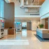 Atlantis Rent vending machines in modern office lobby with neutral colors and seating area