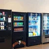 Machine Rent Noida showing black vending machines stocked with snacks and beverages for office use