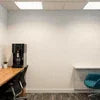 Black Keurig coffee machine for office use on a white table in a Gurgaon workspace for Coffee machine Rent Gurgaon