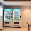 Two white tea vending machines Gurgaon in office setting with beverage selections and digital displays