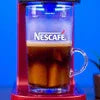 Nescafe Coffee Machine in delhi with red base brewing black Nescafe coffee in clear glass cup