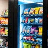 Modern black office vending machine stocked with snacks for Office Vending Machine Rent in Delhi