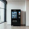 Atlantis Machine Noida black vending machine model in office setting by window