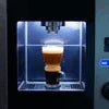 Black coffee vending machine dispensing coffee into a glass cup with Coffee Vending Machine Solutions in Delhi