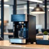 Black DeLonghi coffee machine model on office counter for Coffee Machine Rent Faridabad
