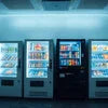 Atlantis Vending Rental Delhi offers white and black vending machines with various snacks and drinks for office use