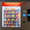 Red and silver vending machine Gurgaon stocked with snacks and beverages for office use