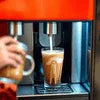 Mocha Premix in Noida served from an orange vending machine into a clear glass for office use