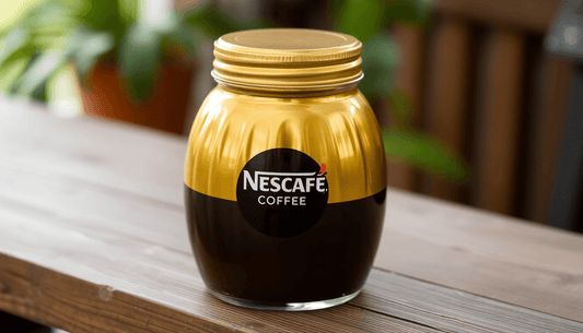 A golden jar of Nescafe coffee on a wooden table