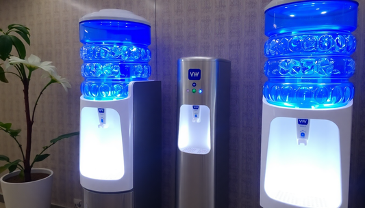 Atlantis Select water dispensers with glowing blue water bottles in a modern office setting