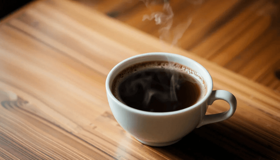 A steaming cup of coffee on a wooden table