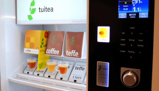 Modern vending machine dispensing tea and coffee