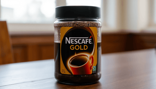 A jar of Nescafe Gold coffee on a wooden table