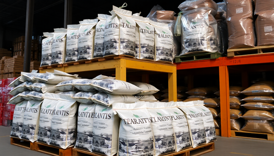 Bags of Atlantis tea coffee premix stacked in warehouse