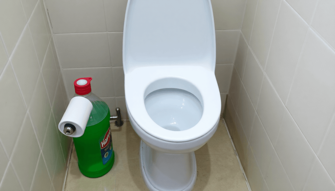 A clean toilet with Harpic cleaner bottle in Sector 49